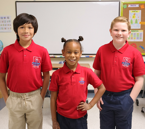 Student raising hand in classroom